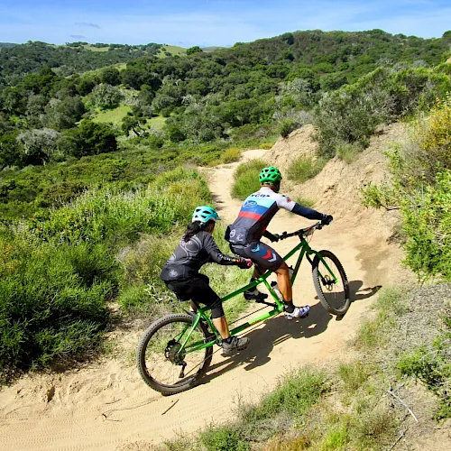 A mountain biker riding a dirt trail in the Fort Ord hills